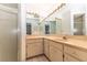 Bathroom showcasing a large vanity with ample lighting and a glass-enclosed shower at 12196 Ne 4Th Pl, Oxford, FL 34484