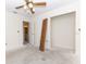 Bedroom featuring bright walls, open closet, and a glimpse into an adjacent bathroom at 12196 Ne 4Th Pl, Oxford, FL 34484