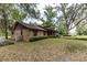 Spacious property featuring a brick home, large backyard, and beautiful mature trees at 12196 Ne 4Th Pl, Oxford, FL 34484
