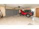 Spacious garage featuring an automatic door and a parked red Jeep at 12196 Ne 4Th Pl, Oxford, FL 34484