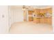 Cozy kitchen area with classic cabinetry, a ceiling fan, and direct access to the backyard at 12196 Ne 4Th Pl, Oxford, FL 34484
