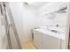 Efficient laundry room includes a washer, dryer, utility sink, and storage shelves at 12196 Ne 4Th Pl, Oxford, FL 34484