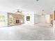 Bright living room featuring a brick fireplace, ceiling fans, and multiple windows for natural light at 12196 Ne 4Th Pl, Oxford, FL 34484