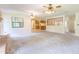Open-concept living area with brick accents, ceiling fans, and seamless flow to the kitchen at 12196 Ne 4Th Pl, Oxford, FL 34484
