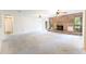 Spacious living room with a brick fireplace, large windows, and ample natural light at 12196 Ne 4Th Pl, Oxford, FL 34484