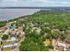 Beautiful aerial view of homes nestled among lush trees near the lake, creating a serene, neighborhood setting at 1254 Magnolia Farms Ct, Eustis, FL 32726