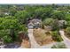 Aerial view showcasing the property's landscaping and location in a tree-filled neighborhood at 1254 Magnolia Farms Ct, Eustis, FL 32726