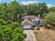 Aerial view of a well maintained home, landscaping, and driveway at 1254 Magnolia Farms Ct, Eustis, FL 32726