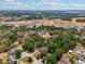 Expansive aerial view showcasing the neighborhood, new construction, and lush greenery at 1254 Magnolia Farms Ct, Eustis, FL 32726