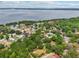 Beautiful aerial showcasing neighborhood, surrounding trees, and stunning lake views at 1254 Magnolia Farms Ct, Eustis, FL 32726