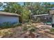 Spacious backyard features a shed, mature trees, and a screened-in pool area at 1254 Magnolia Farms Ct, Eustis, FL 32726
