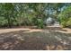 Large backyard with mature trees and a wall surrounding the property at 1254 Magnolia Farms Ct, Eustis, FL 32726