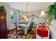 Elegant dining room featuring a chandelier, large window, and traditional furnishings at 1254 Magnolia Farms Ct, Eustis, FL 32726