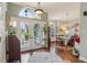 Welcoming foyer with decorative front doors, hardwood floors, and elegant lighting at 1254 Magnolia Farms Ct, Eustis, FL 32726