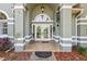 Welcoming front entrance with double doors, arched window and a covered portico at 1254 Magnolia Farms Ct, Eustis, FL 32726
