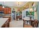 Charming kitchen with a dining area and views of the pool, featuring tile floors and decorative accents at 1254 Magnolia Farms Ct, Eustis, FL 32726