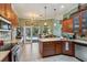 A bright kitchen with stainless appliances, island and pool access, blending style with functionality at 1254 Magnolia Farms Ct, Eustis, FL 32726