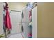 Functional laundry room with stacked washer and dryer, plus extra storage, making laundry chores a breeze at 1254 Magnolia Farms Ct, Eustis, FL 32726
