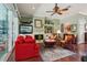 Cozy living room features a fireplace, built-in shelving, and a ceiling fan at 1254 Magnolia Farms Ct, Eustis, FL 32726