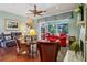 Cozy living room with comfortable seating, hardwood floors, and a view of the screened-in patio at 1254 Magnolia Farms Ct, Eustis, FL 32726