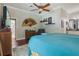 Spacious main bedroom with hardwood floors, a ceiling fan, and access to the main bathroom at 1254 Magnolia Farms Ct, Eustis, FL 32726