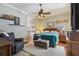 Spacious main bedroom with a ceiling fan, wood floors, and access to the bathroom at 1254 Magnolia Farms Ct, Eustis, FL 32726