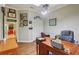 Bright office space with a large desk, hardwood floors, and natural light at 1254 Magnolia Farms Ct, Eustis, FL 32726