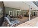 Covered patio features lounge seating and a dining area with beautiful brick pavers and string lights at 1254 Magnolia Farms Ct, Eustis, FL 32726