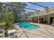 Pool with outdoor living space, lush landscaping and lots of space for outdoor enjoyment at 1254 Magnolia Farms Ct, Eustis, FL 32726