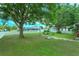 A spacious backyard featuring mature trees and an outdoor seating area at 12846 Brown Bark Trl, Clermont, FL 34711