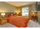 A cozy bedroom with two-tone walls and a large window for natural light at 12846 Brown Bark Trl, Clermont, FL 34711