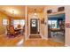 Bright entryway with wood floors, decorative lighting, and a view into the dining area at 12846 Brown Bark Trl, Clermont, FL 34711