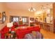Spacious living room with bar seating, brick columns, bright walls, and access to the kitchen at 12846 Brown Bark Trl, Clermont, FL 34711