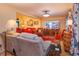 Cozy living room featuring a large TV, wood floors, and comfortable seating at 12846 Brown Bark Trl, Clermont, FL 34711
