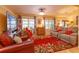 Bright living room with hardwood floors, comfortable seating, and bright natural light at 12846 Brown Bark Trl, Clermont, FL 34711