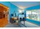 Bright office with large windows and blue accent wall at 12846 Brown Bark Trl, Clermont, FL 34711