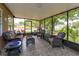 Comfortable screened patio area with beautiful outdoor seating at 12846 Brown Bark Trl, Clermont, FL 34711