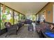A large screened patio with wicker furniture and a hot tub at 12846 Brown Bark Trl, Clermont, FL 34711