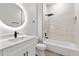 Bathroom featuring a soaking tub with marble surround, a round mirror, and modern black fixtures at 13524 Sw 89 St, Dunnellon, FL 34432