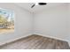 A clean and bright bedroom space with a large window offering natural light and outdoor views at 13524 Sw 89 St, Dunnellon, FL 34432