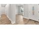 Bright entryway featuring wood-look flooring, white walls, and modern lighting at 13524 Sw 89 St, Dunnellon, FL 34432