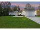Charming one-story home featuring a lush lawn and a two-car garage at dusk at 13524 Sw 89 St, Dunnellon, FL 34432