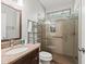 Stylish bathroom featuring granite counters, glass enclosed shower, and unique stained-glass window at 14235 Se 85Th Ave, Summerfield, FL 34491