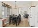 Eat-in kitchen with a view into the living room featuring dark wood table and tile flooring at 14235 Se 85Th Ave, Summerfield, FL 34491