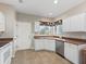 Compact kitchen with white cabinets and a large window, offering a cozy cooking space at 14235 Se 85Th Ave, Summerfield, FL 34491