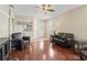 Well-lit living room featuring hardwood floors, natural light, and an open layout at 14235 Se 85Th Ave, Summerfield, FL 34491