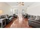 Open living room with gleaming hardwood floors and a ceiling fan at 14235 Se 85Th Ave, Summerfield, FL 34491