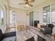 Inviting sunroom with a ceiling fan, lots of windows, and stylish furniture at 14235 Se 85Th Ave, Summerfield, FL 34491