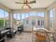 Cozy sunroom with lots of windows, a ceiling fan, and stylish seating at 14235 Se 85Th Ave, Summerfield, FL 34491