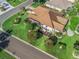 Aerial shot showcases a well-manicured lawn with lush landscaping and a screened-in porch creating a private outdoor retreat at 1501 Lavaca Ln, The Villages, FL 32159